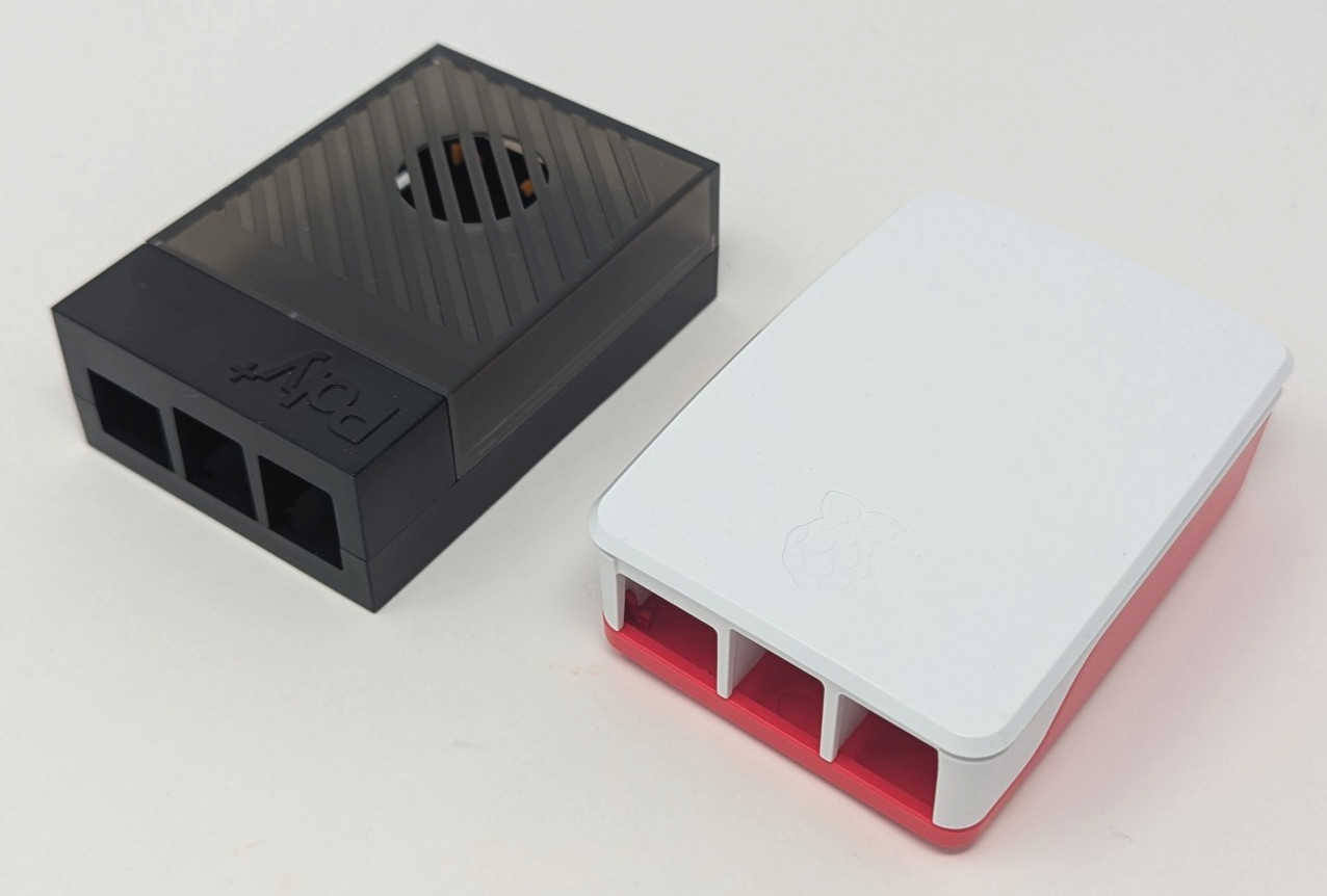 2x Raspberry Pi Cases (1x official red/white with fan, 1x Poly+)