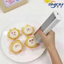 New handheld inkjet printer prints patterns, text, and numbers on food picture